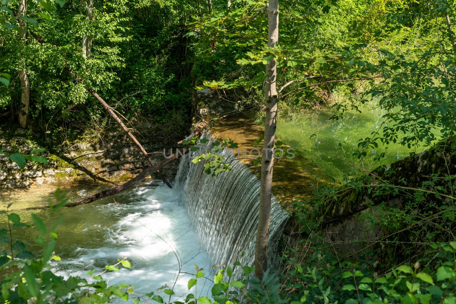 Waterfall at a barrage in the forest in the Bavarian Forest Chiemgau Germany