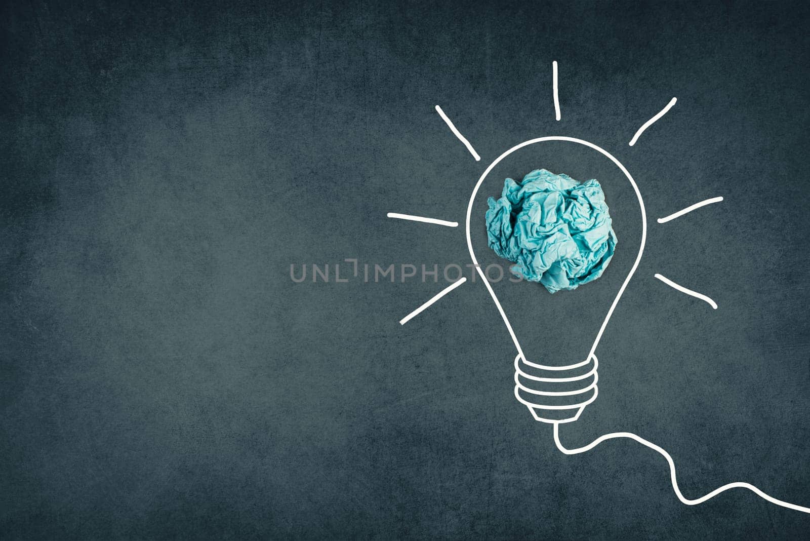 A white bulb on a dark brown textured background, symbol for idea, creativity, business, planing