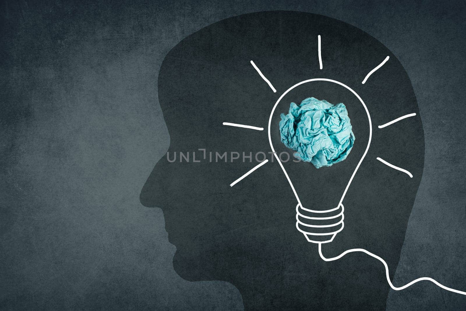 Silhouette of a face with a lightbulb, textured background, empty copy space for text