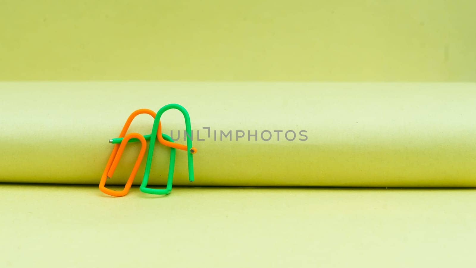 Happy couple sitting in a sweet pose. Abstract Human Figure of Paper Clip. Creative Photography. Still Life. Copy Space