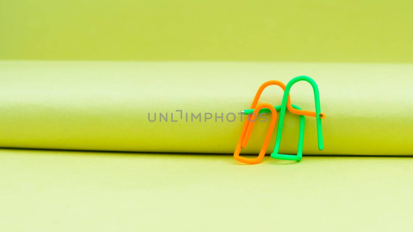 Happy couple sitting in a sweet pose. Abstract Human Figure of Paper Clip. Creative Photography. Still Life. Copy Space
