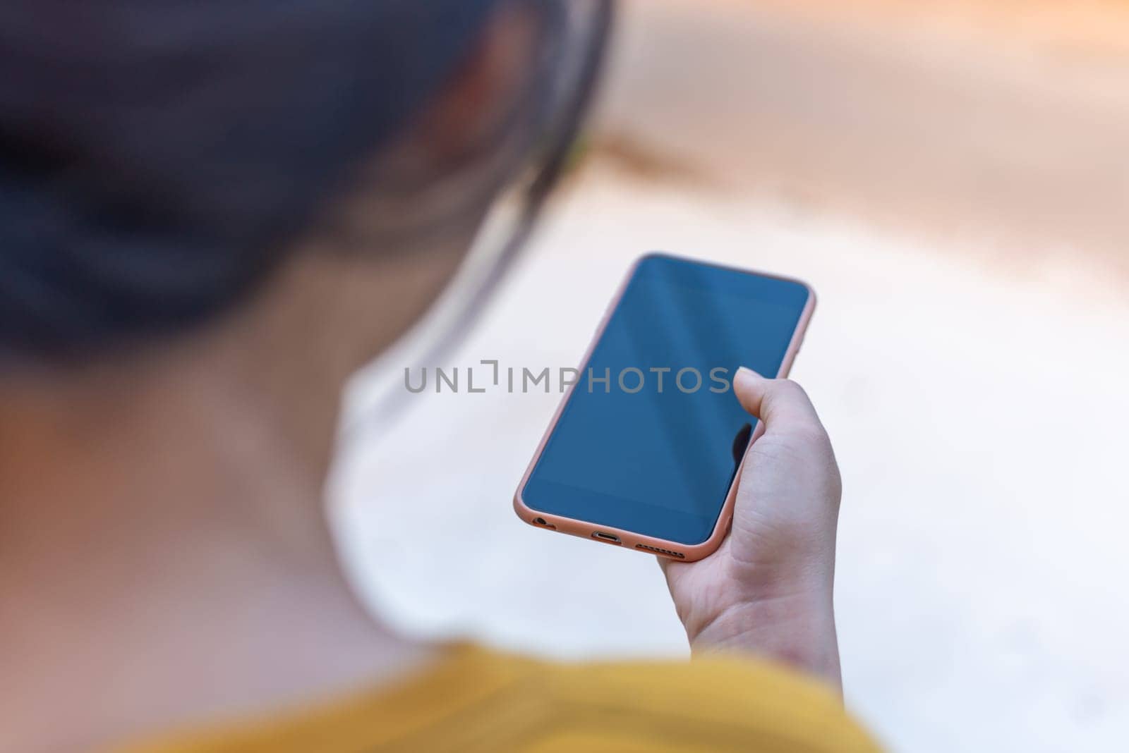 Hand women with smart phone black screen blurred background