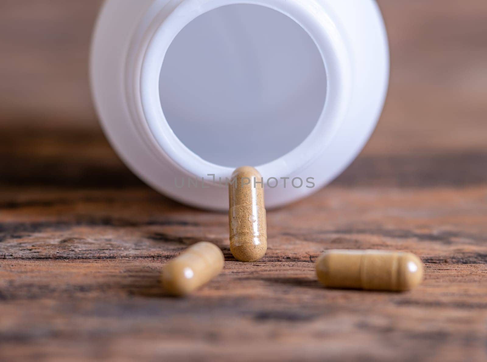 Pill spilling out of a bottle blurred background, Medicine capsule for health, Vitamin spilling out from bottle, Macro