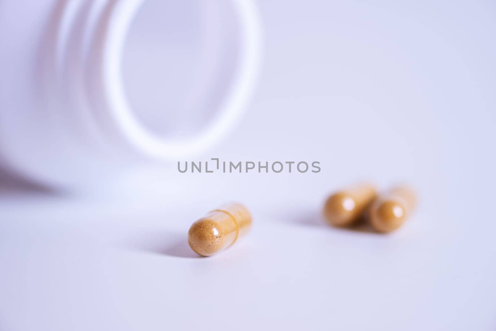 Pill spilling out of a bottle blurred background, Medicine capsule for health, Vitamin spilling out from bottle, Macro