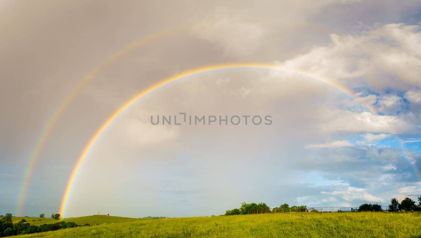 Panoramic view of Central Kentucky countryside with double rainbow after storm