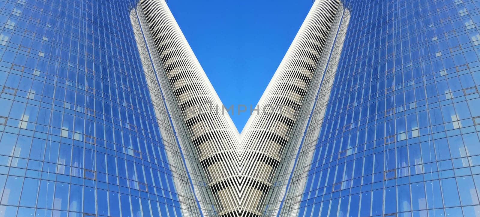 Abstract image of an office building with glass windows. Business and finance. Office architecture. The building is made of concrete and glass. Template for text. Urban geometric architecture.