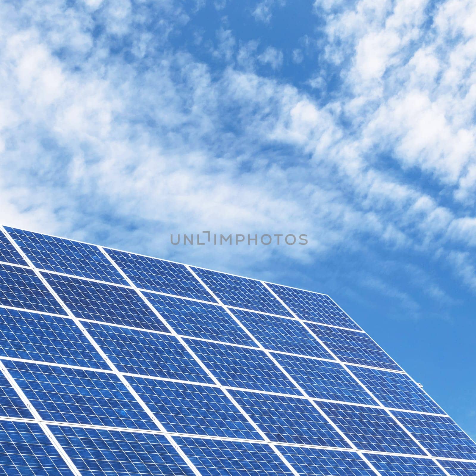 Solar panels for clean energy with a blue sky background.