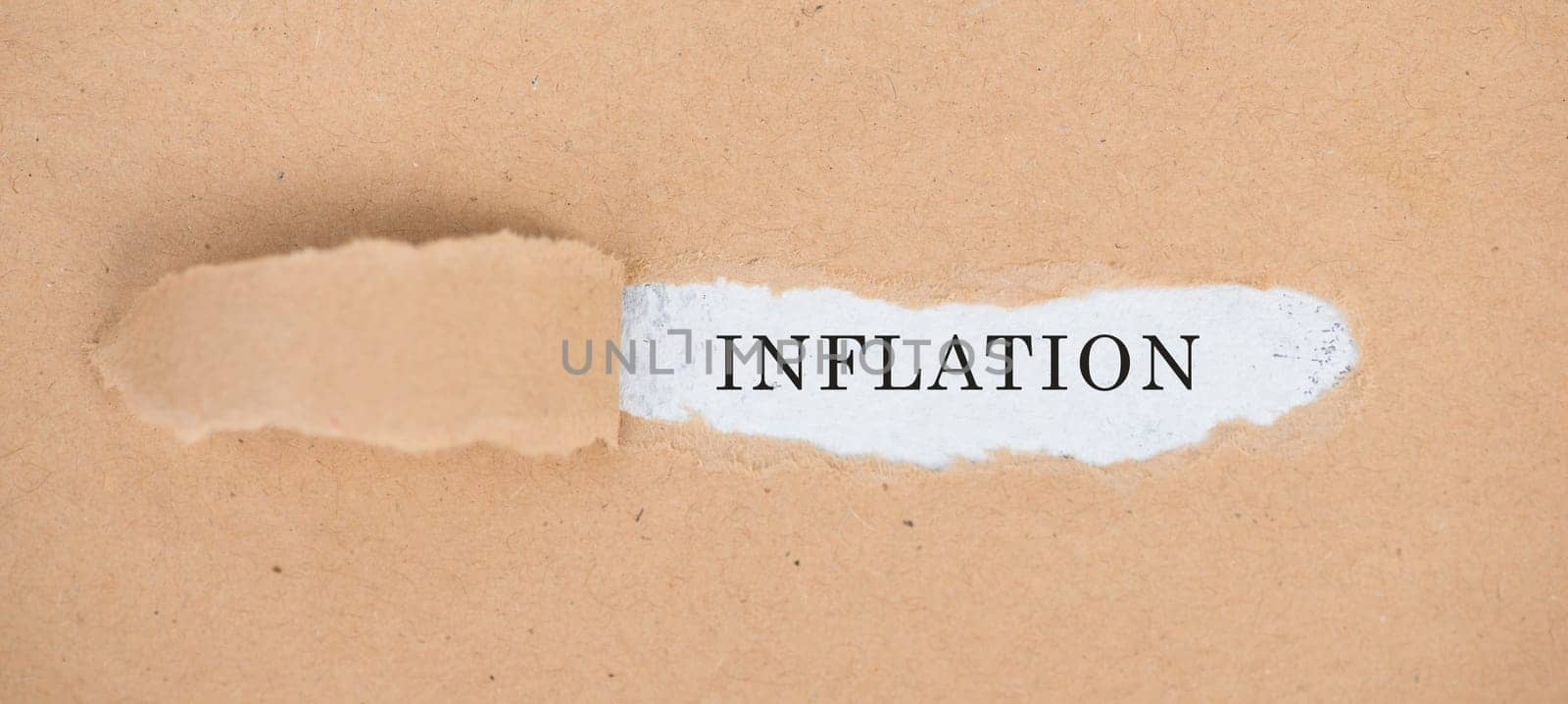 The word inflation is standing on a white background, ripped textured paper