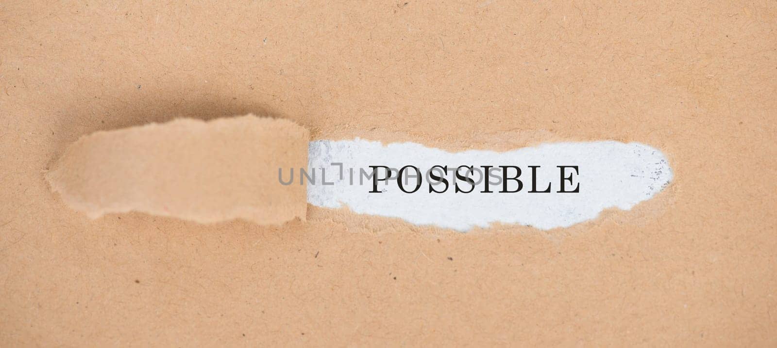 The word possible is standing on a white background, ripped textured paper