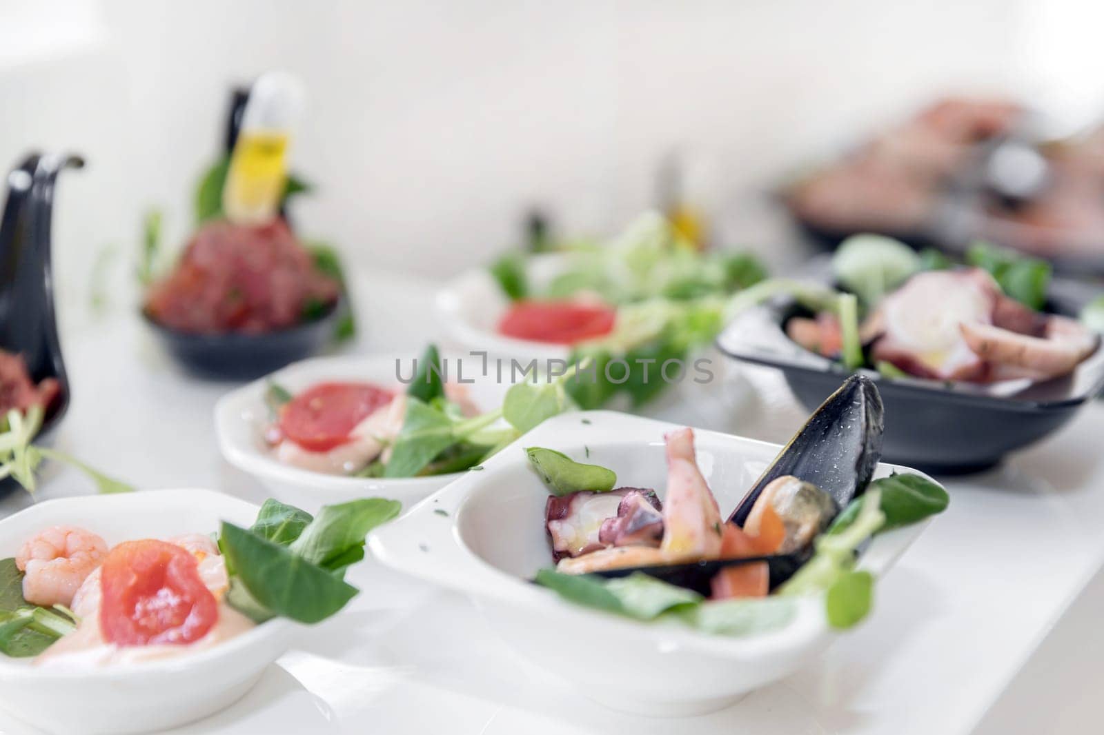 Light seafood snacks on a buffet table. Assorted mini quick, delicacies and snacks, restaurant seafood at event. Wedding party. Gala reception. Decorated delicious table for a party goodies.