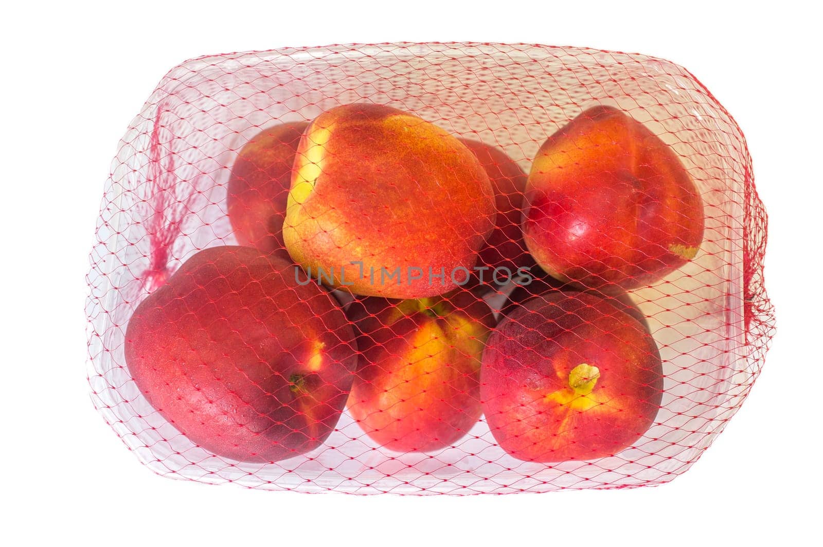 Nectarines on their plastic package covered. Closeup