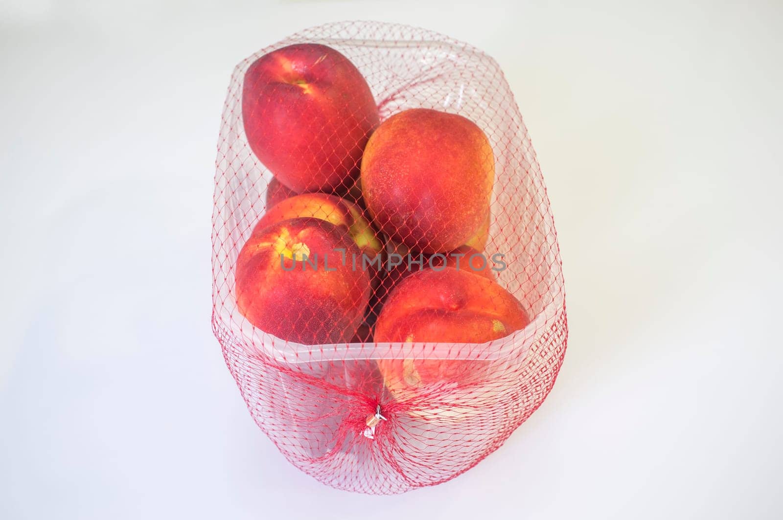 Nectarines on their plastic package covered. Closeup