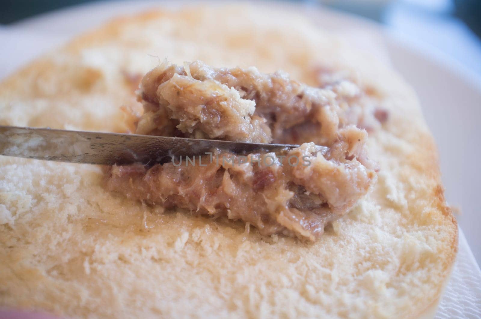 Loin zurrapa pate or lard with pork flakes been spreaded by knife. Selective focus