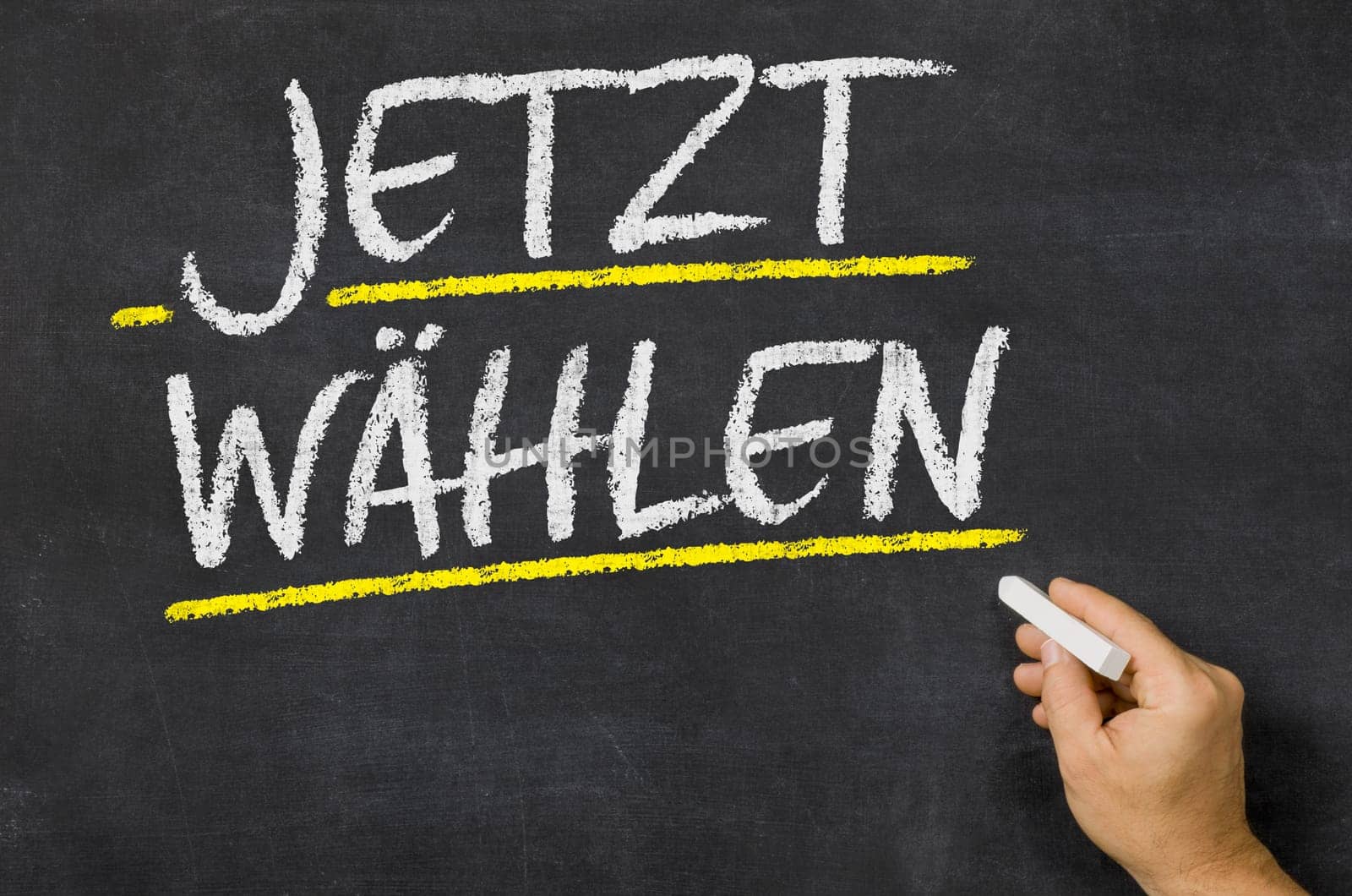 Text on a blackboard - Vote now in german - Jetzt wählen