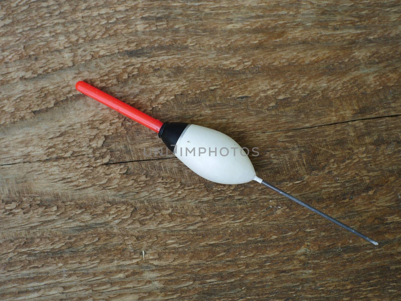 large white bobber with red antenna close-up, still life