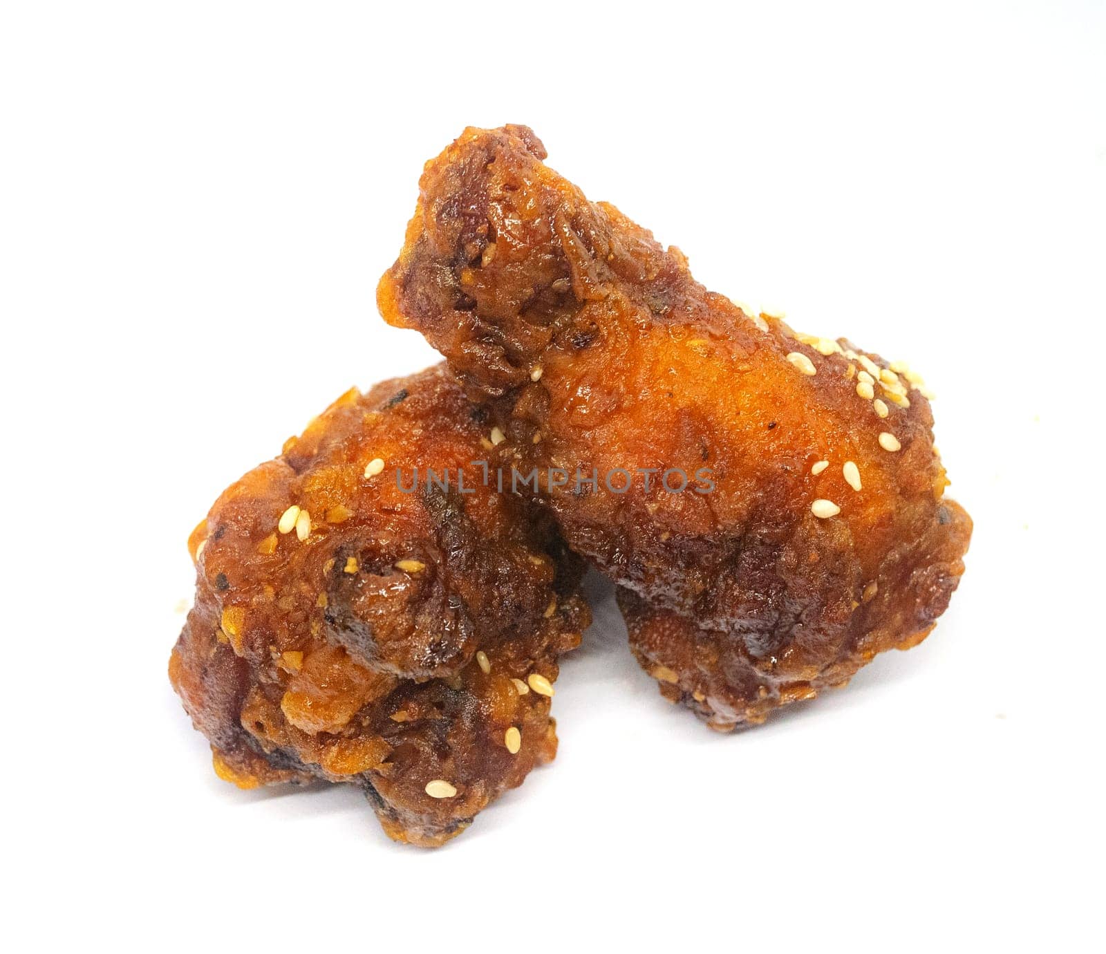 Korean style fried chicken in spicy and sour sauce. Isolated on withe background.