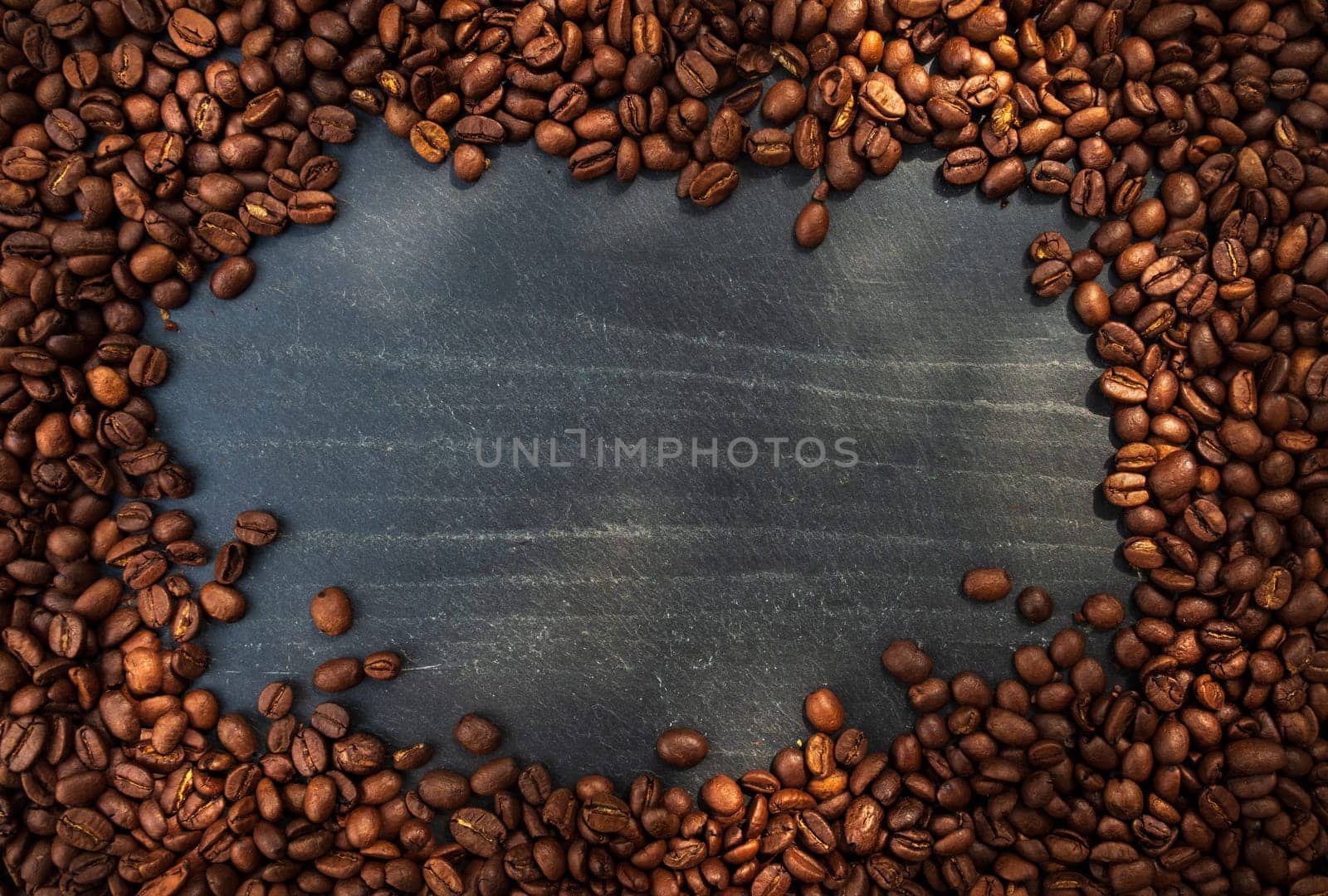 Coffee beans over slate. Top view. Free space for text