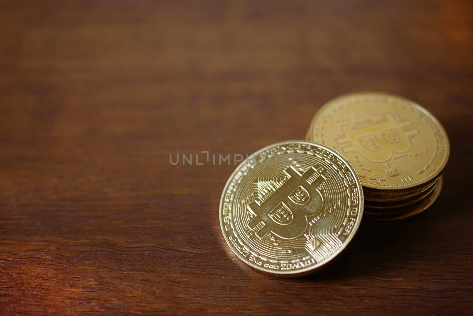 stack of Physical Bitcoins virtual currency on wooden background