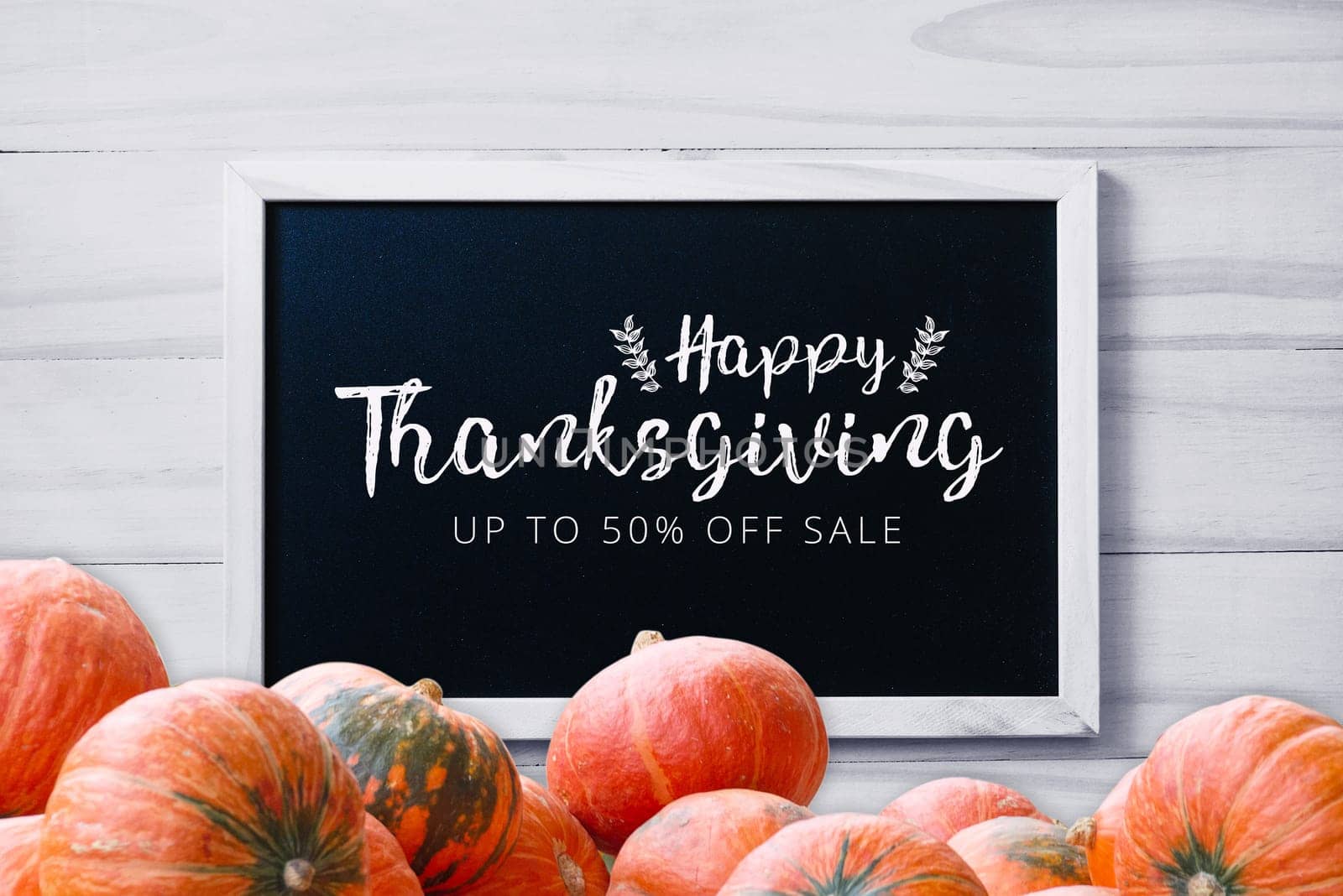 Thanksgiving promotion banner on blackboard on wood white background with stack of pumpkins greeting season