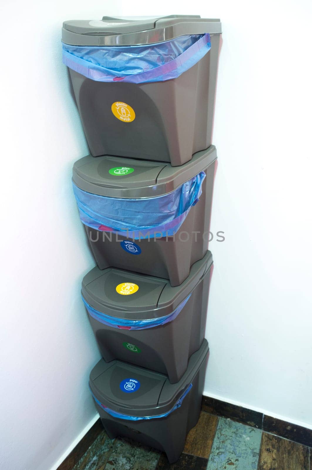 Pile of four waste stackable bins. Separating household waste concept