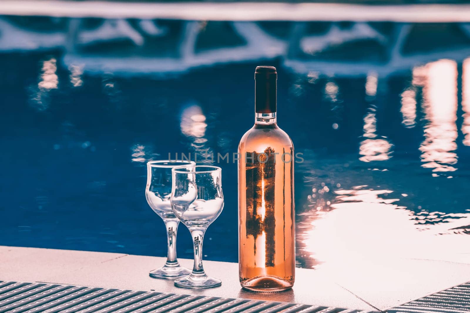 Summer party, wine in glasses near the swiming pool, summer drinks, relaxing by the water