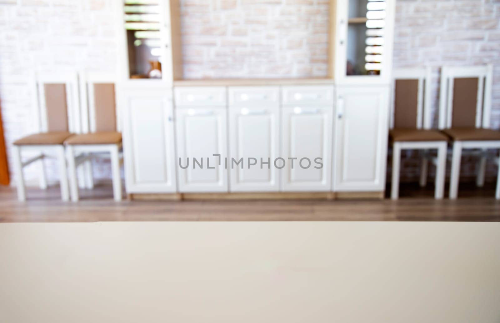 Blurred living room interior and wooden desk space. Home background