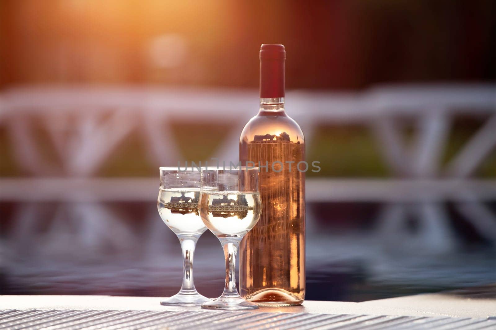 Summer party, wine in glasses near the swiming pool, summer drinks, relaxing by the water