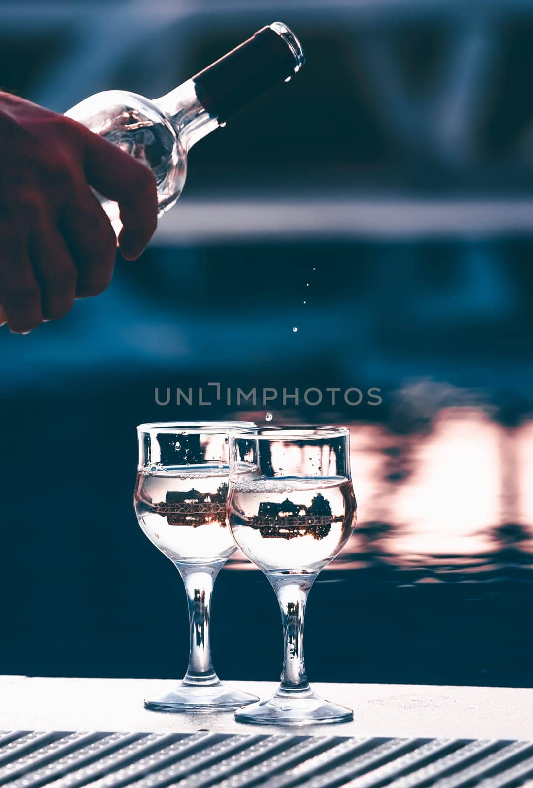 Summer party, wine in glasses near the swiming pool, summer drinks, relaxing by the water