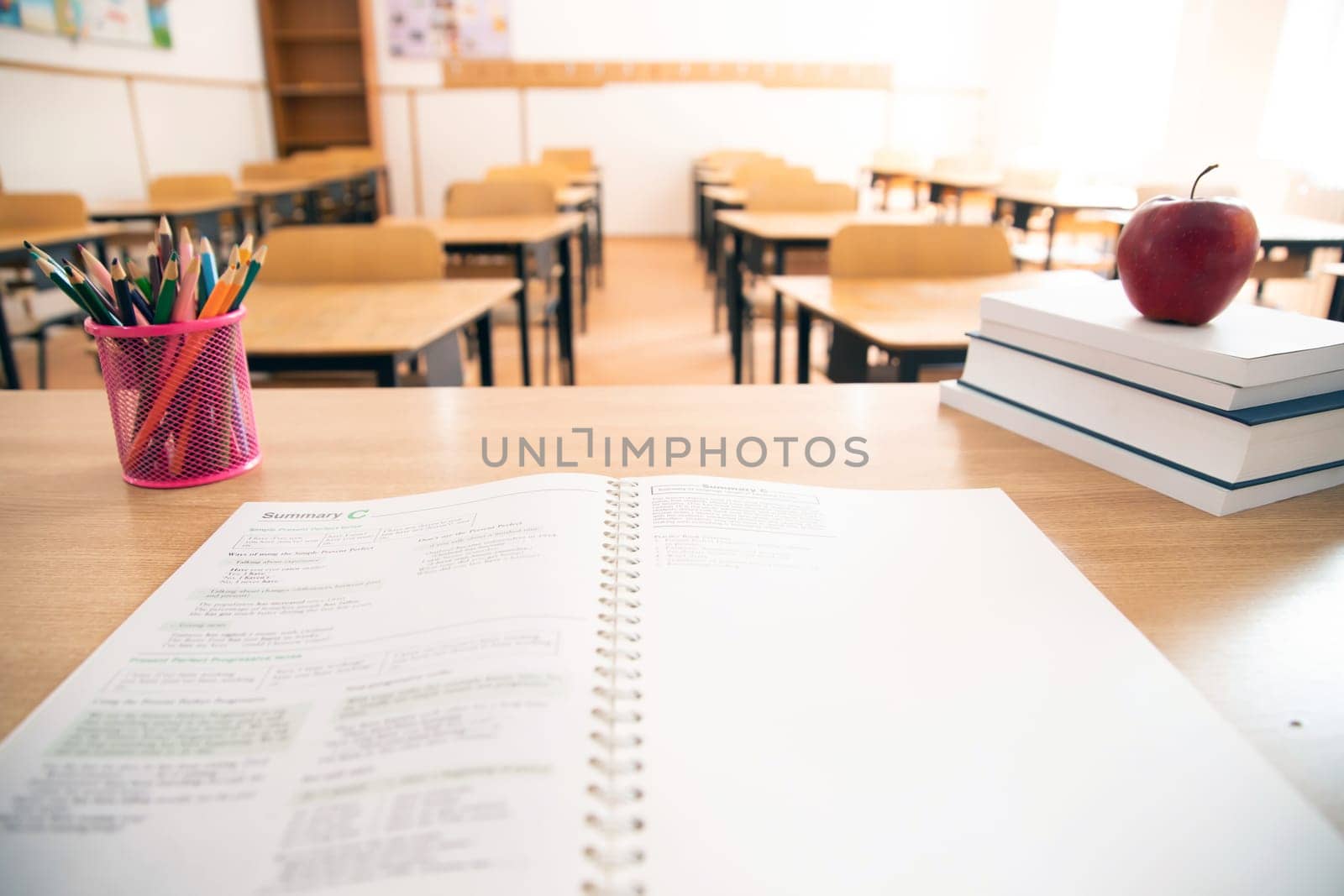 Back to School Concept. Accessories and books, blurred classroom in the background