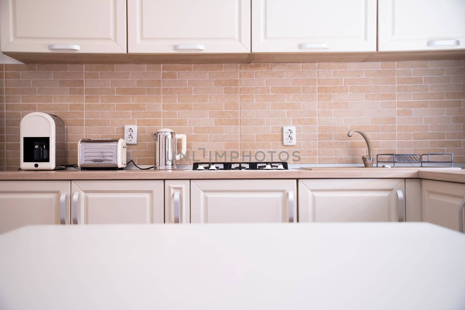 Blurred kitchen interior and white desk space. Home background