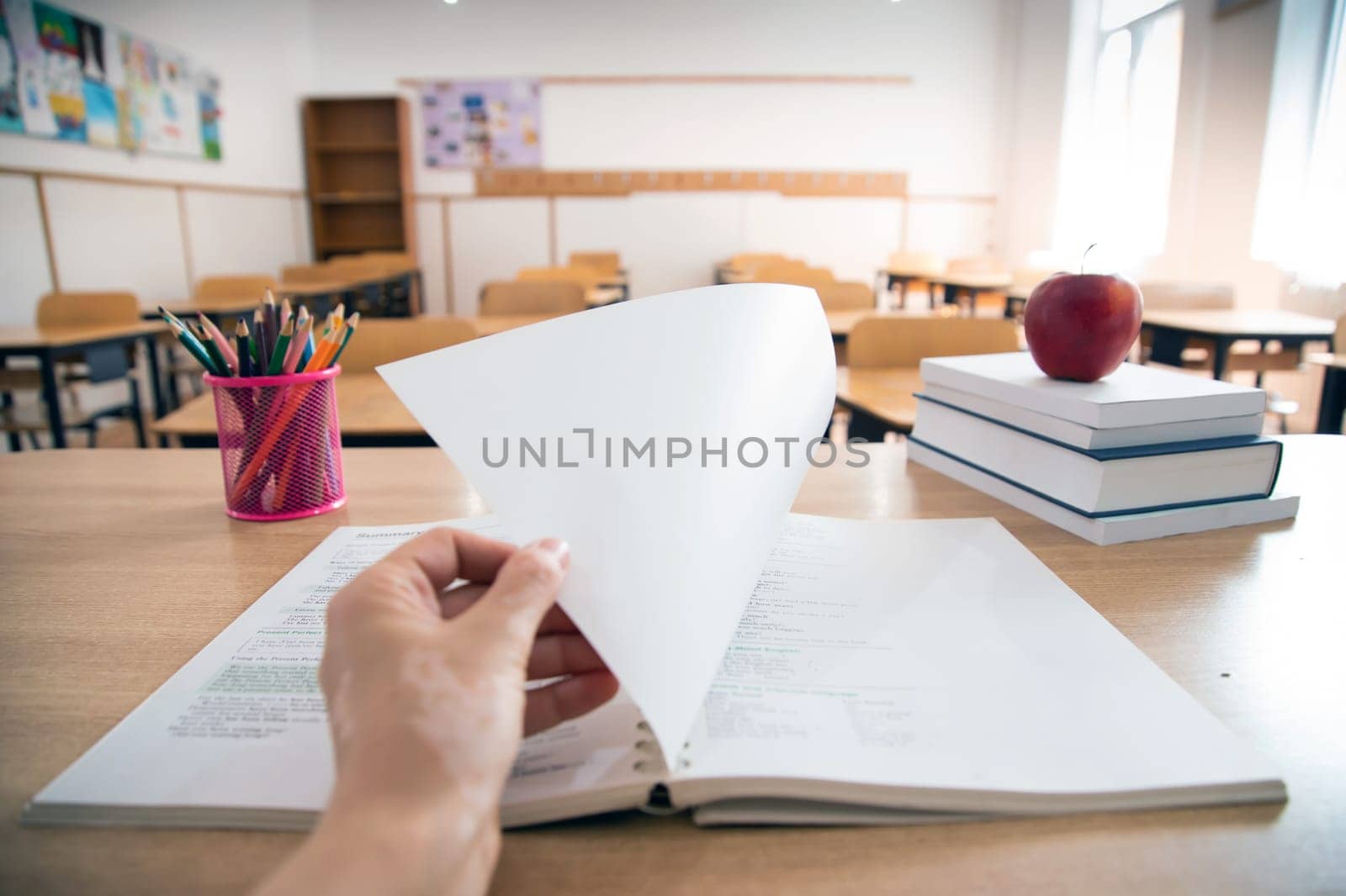 Back to School Concept. Accessories and books, blurred classroom in the background