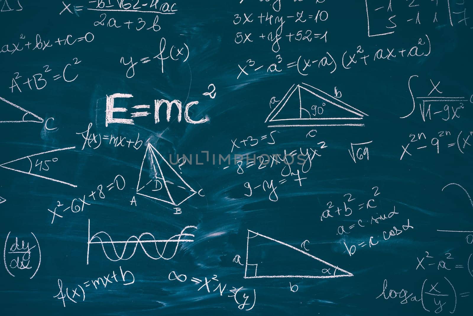 Blackboard inscribed with scientific formulas and calculations in mathematics. Science and education background.