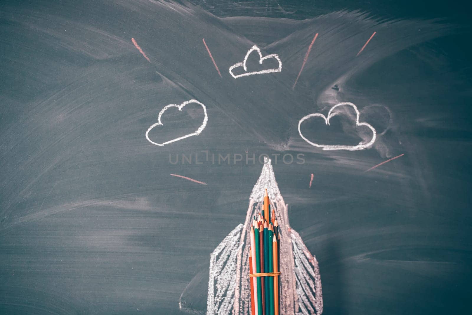 Back to School Concept. Rocket drawing on blackboard and pencils