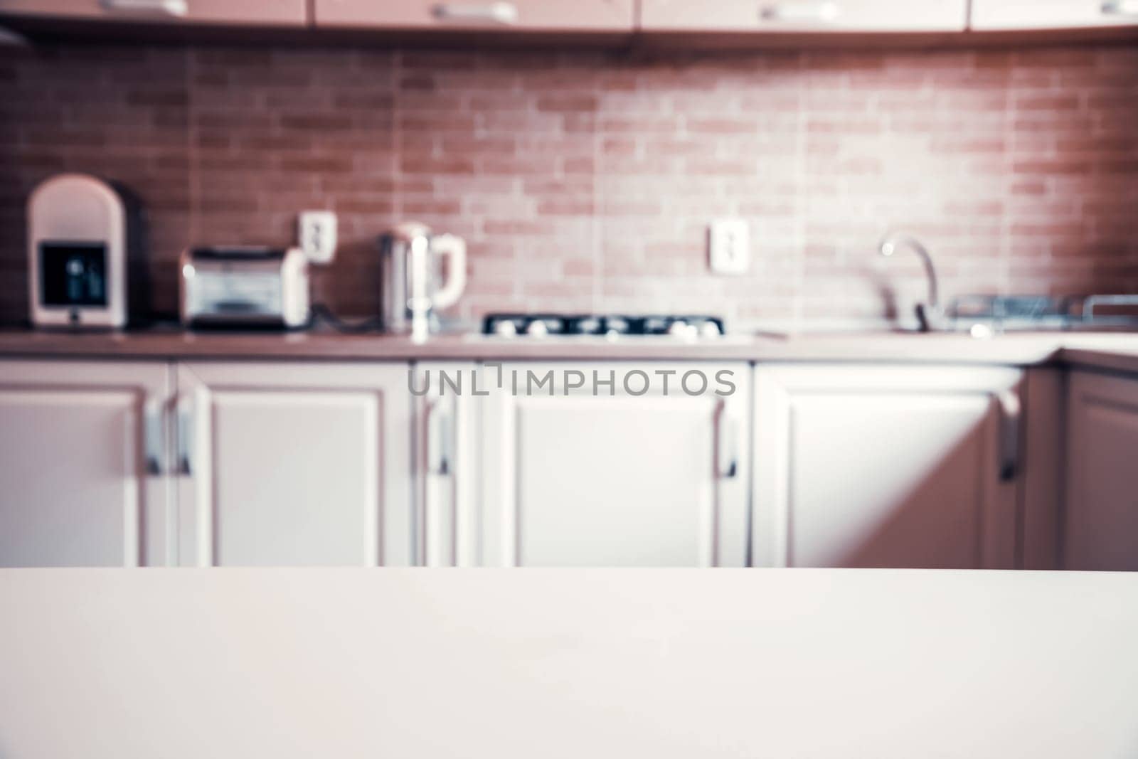 Blurred kitchen interior and white desk space. Home background
