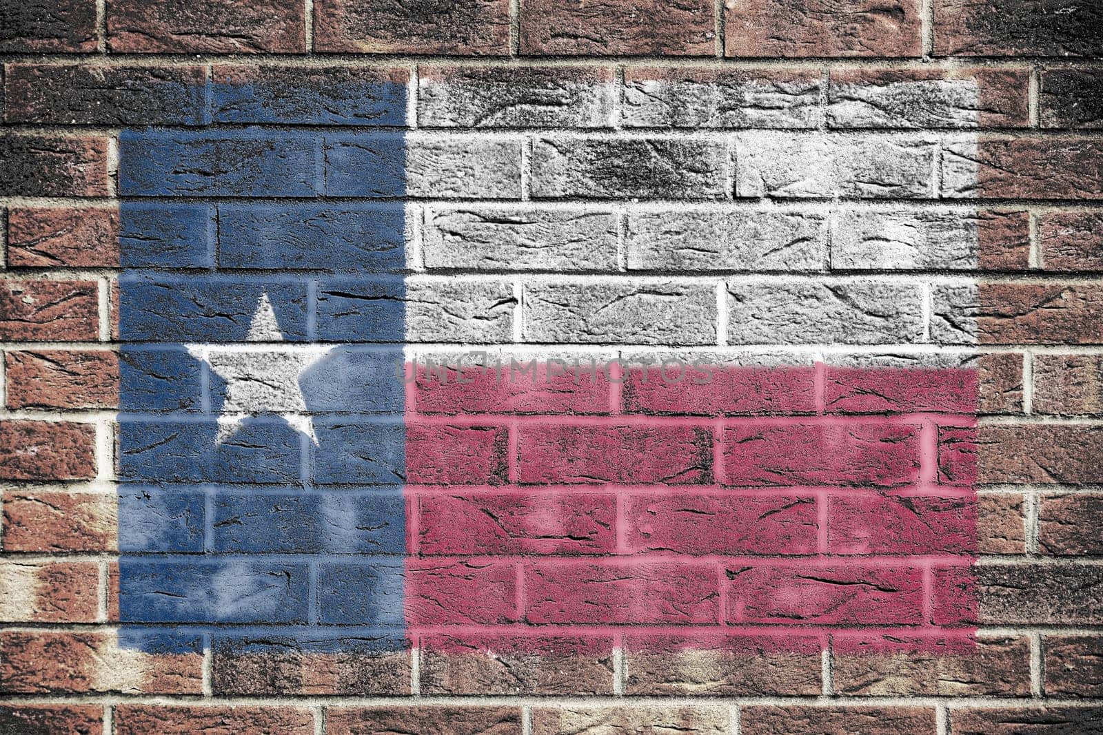 A Texas flag on brick wall background