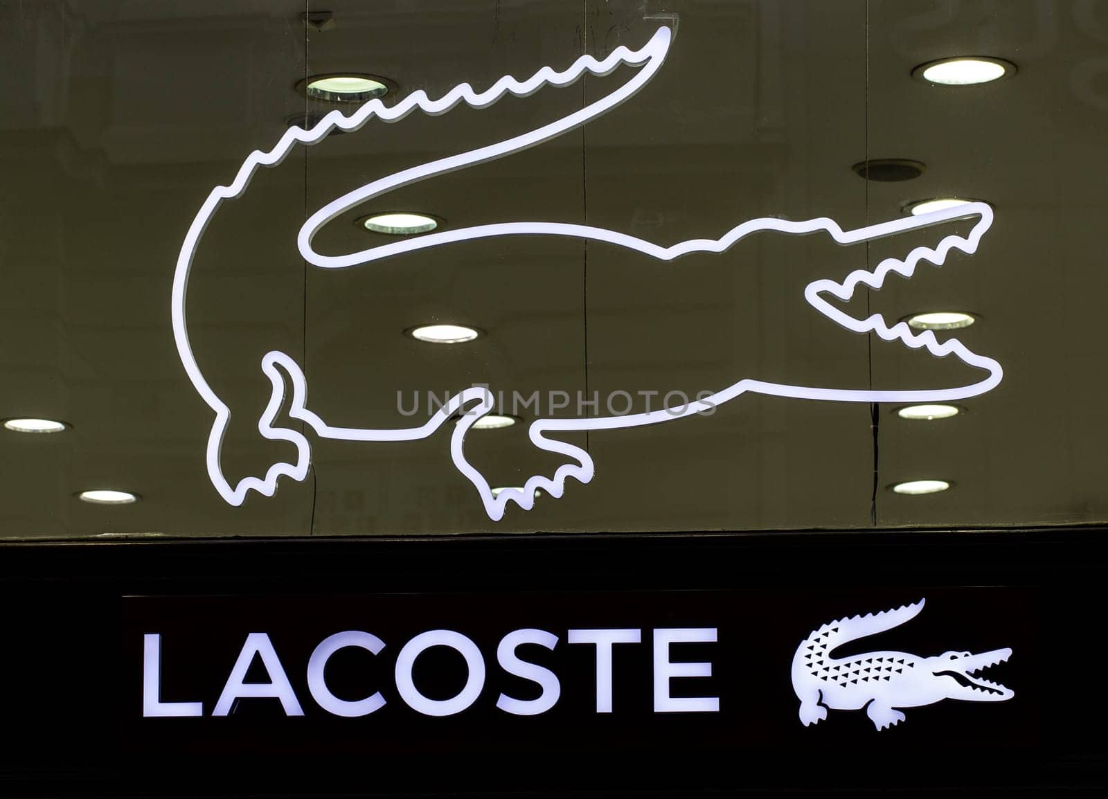 BELGRAD, SERBIA - JULE 16, 2021: Closeup of Lacoste sign on store front, Lacoste is the famous french chain of luxury polo