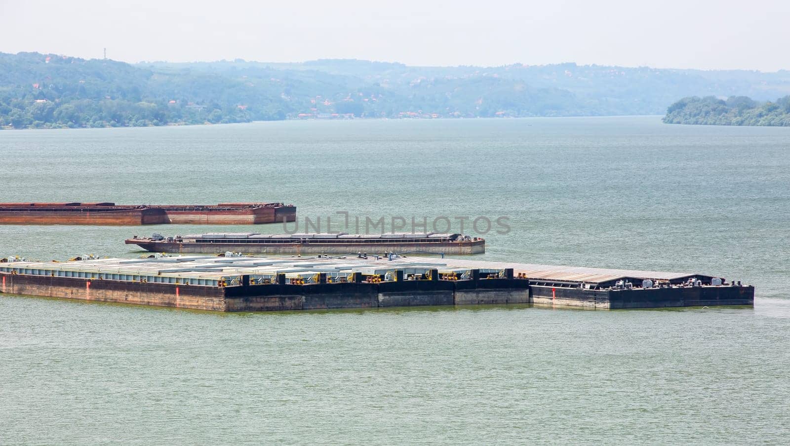 The barge transports cargo on the river. Selectine focus