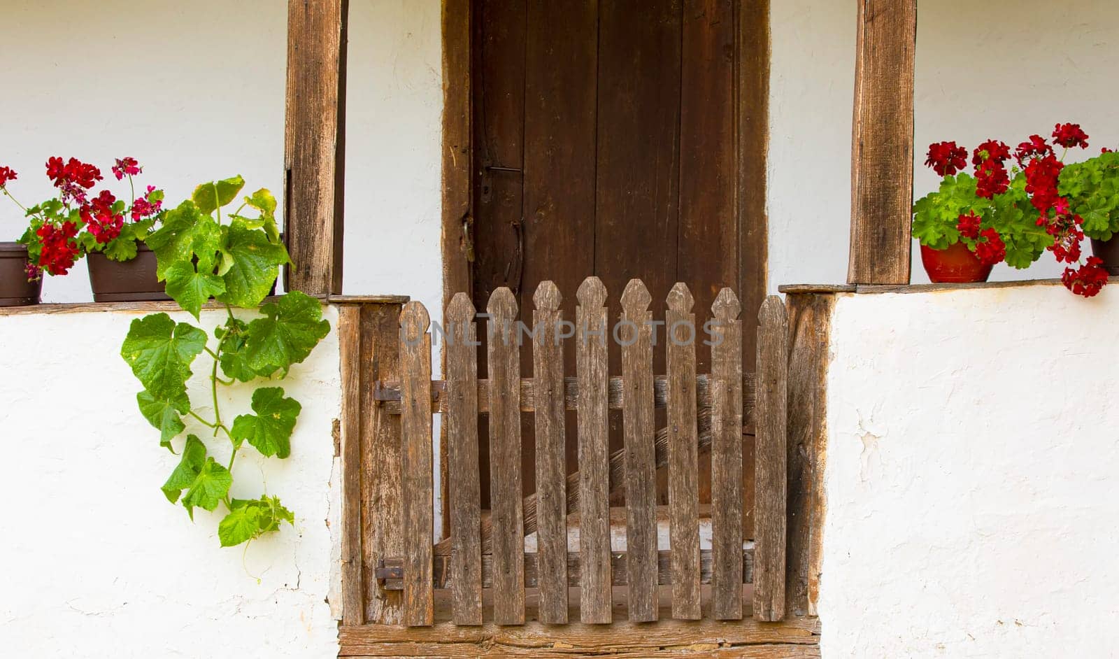 The old wooden  gate to the white village house. Selective focus