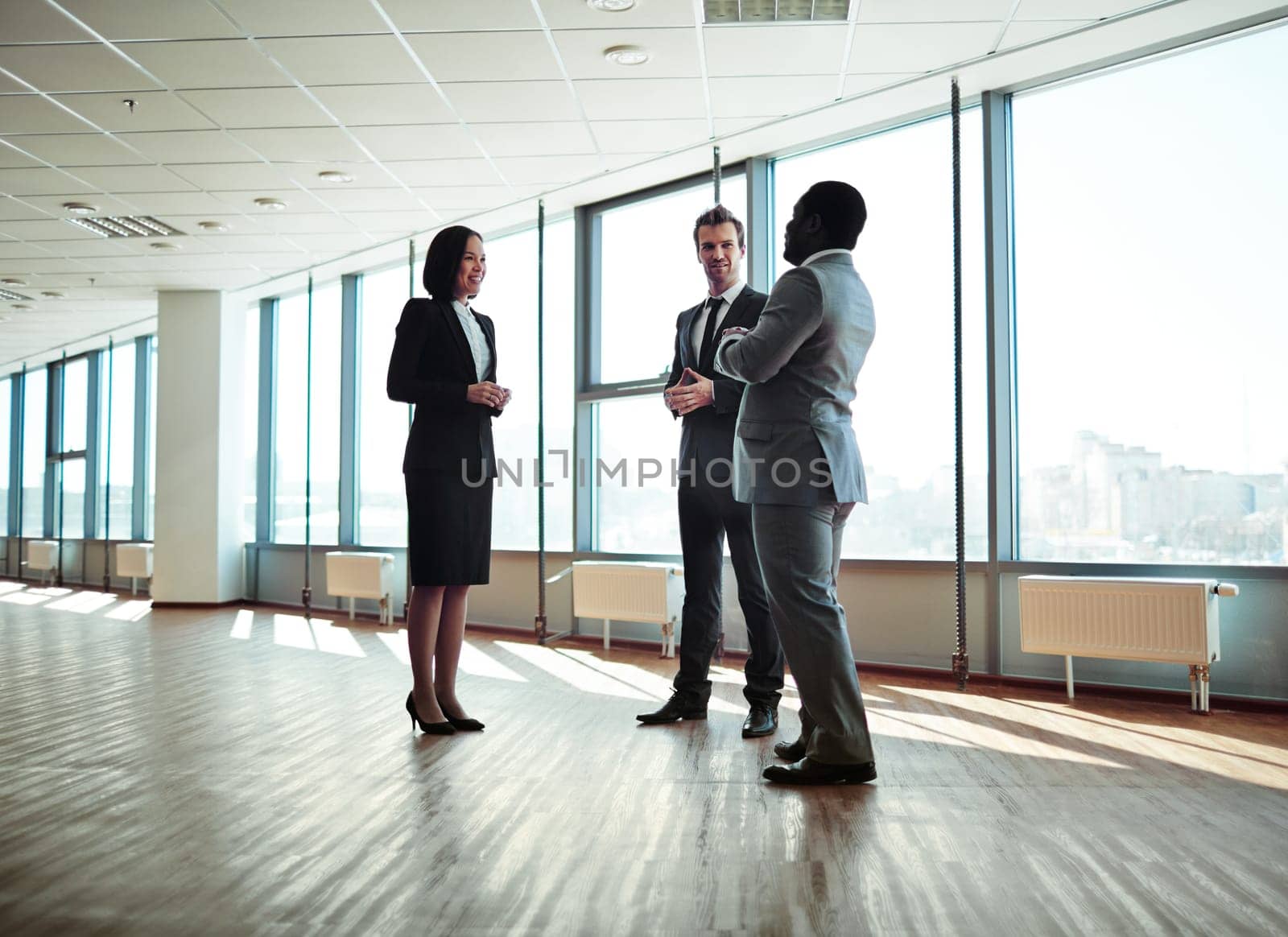 Group of elegant colleagues discussing plans in office