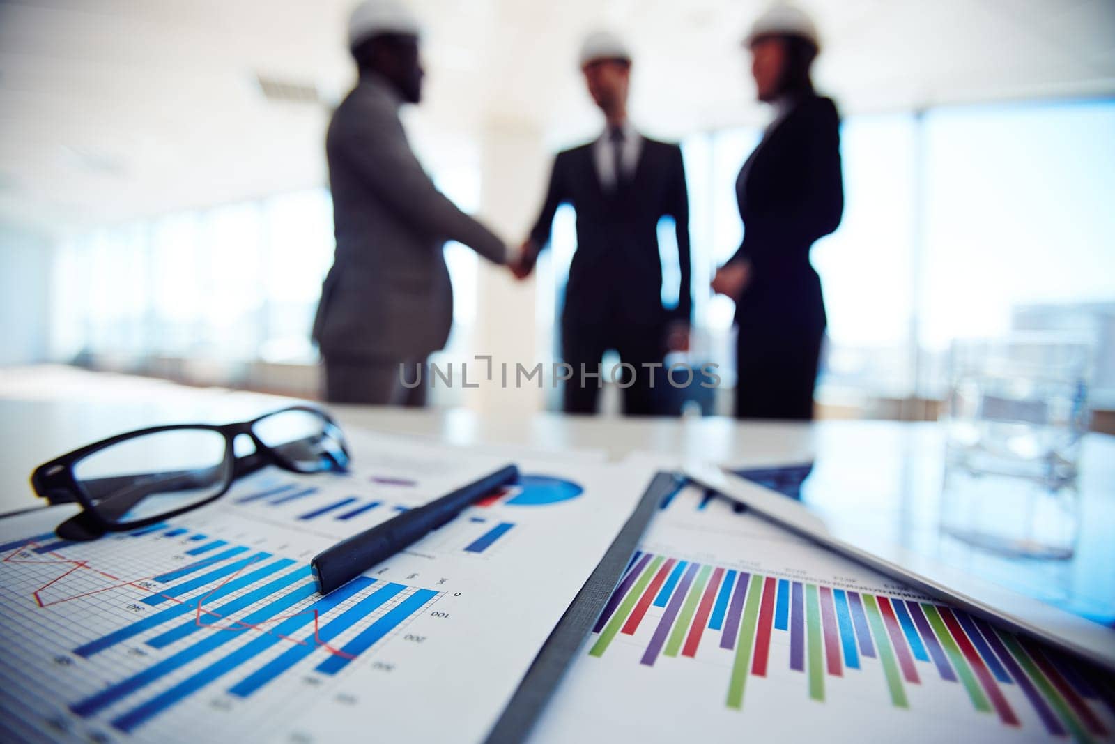 Business documents on background of three business partners