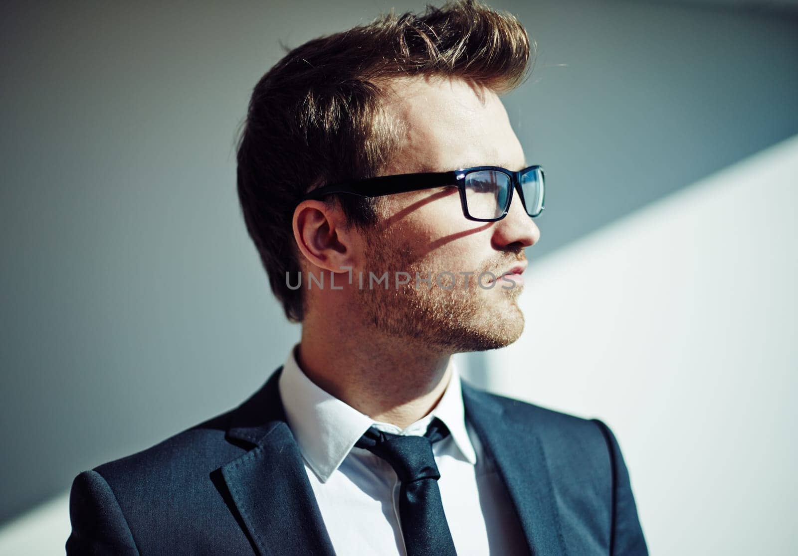Side view of posh young man in eyeglasses