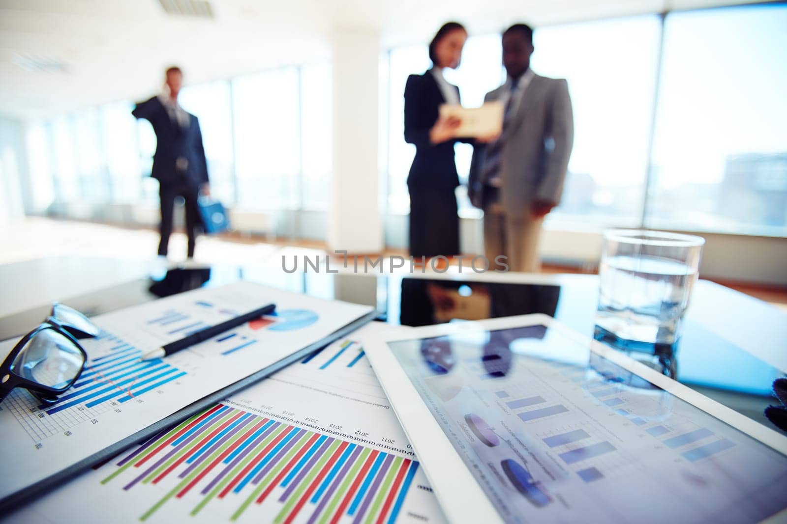 Paper and electronic business documents on desk