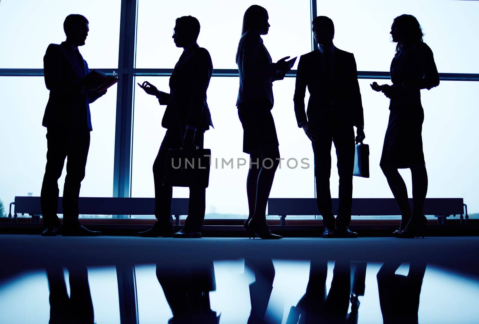 Several employees communicating by office window