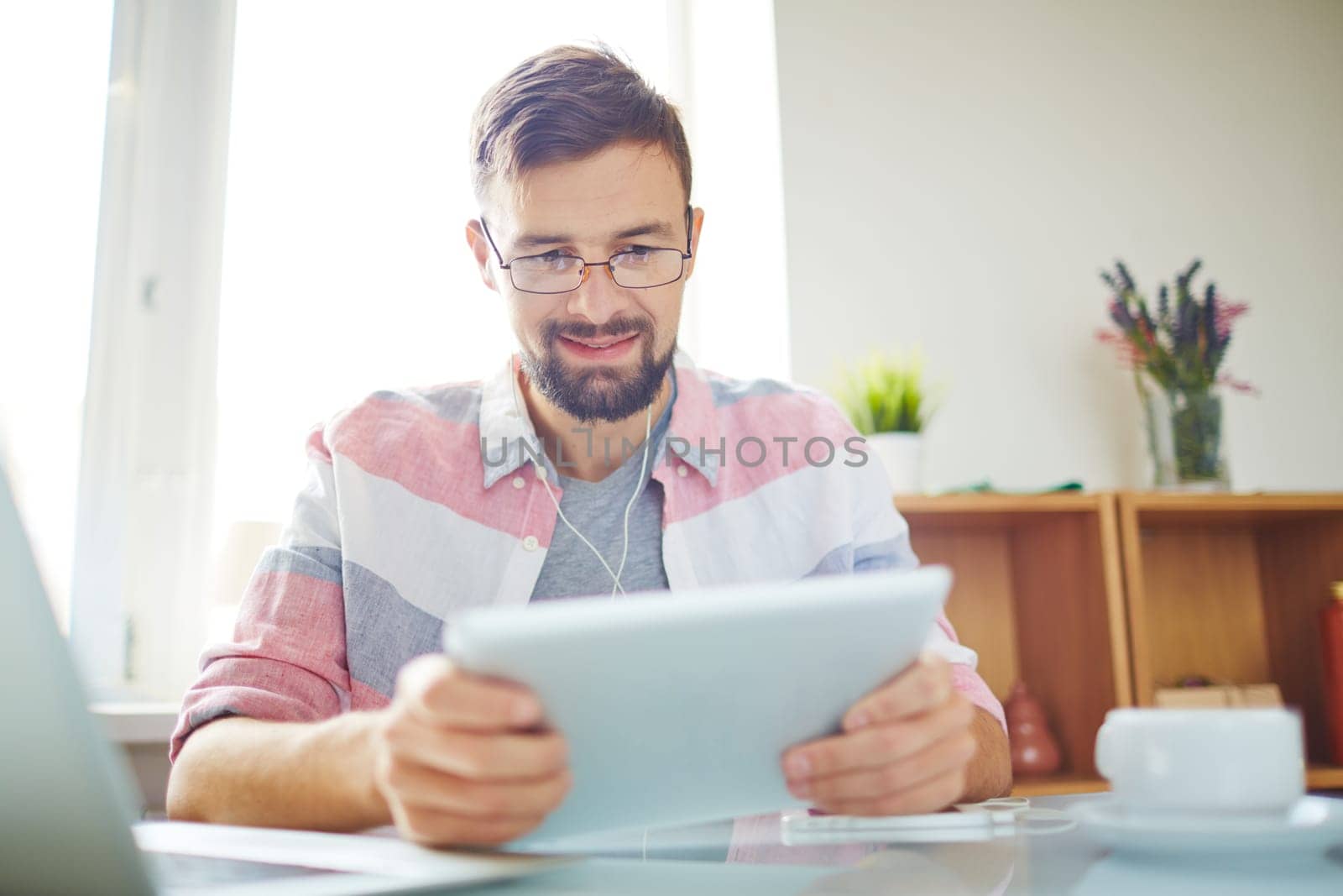 Businessman in casual using digital tablet in office