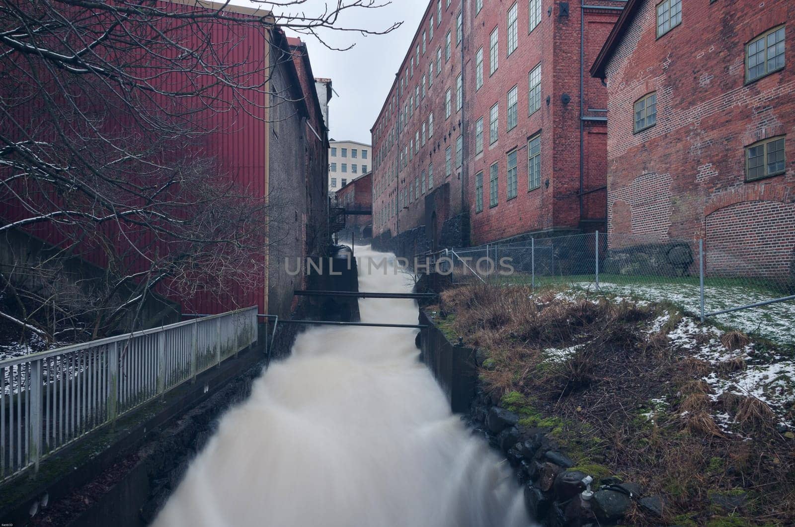 rushing water rushing down from a factory of many building