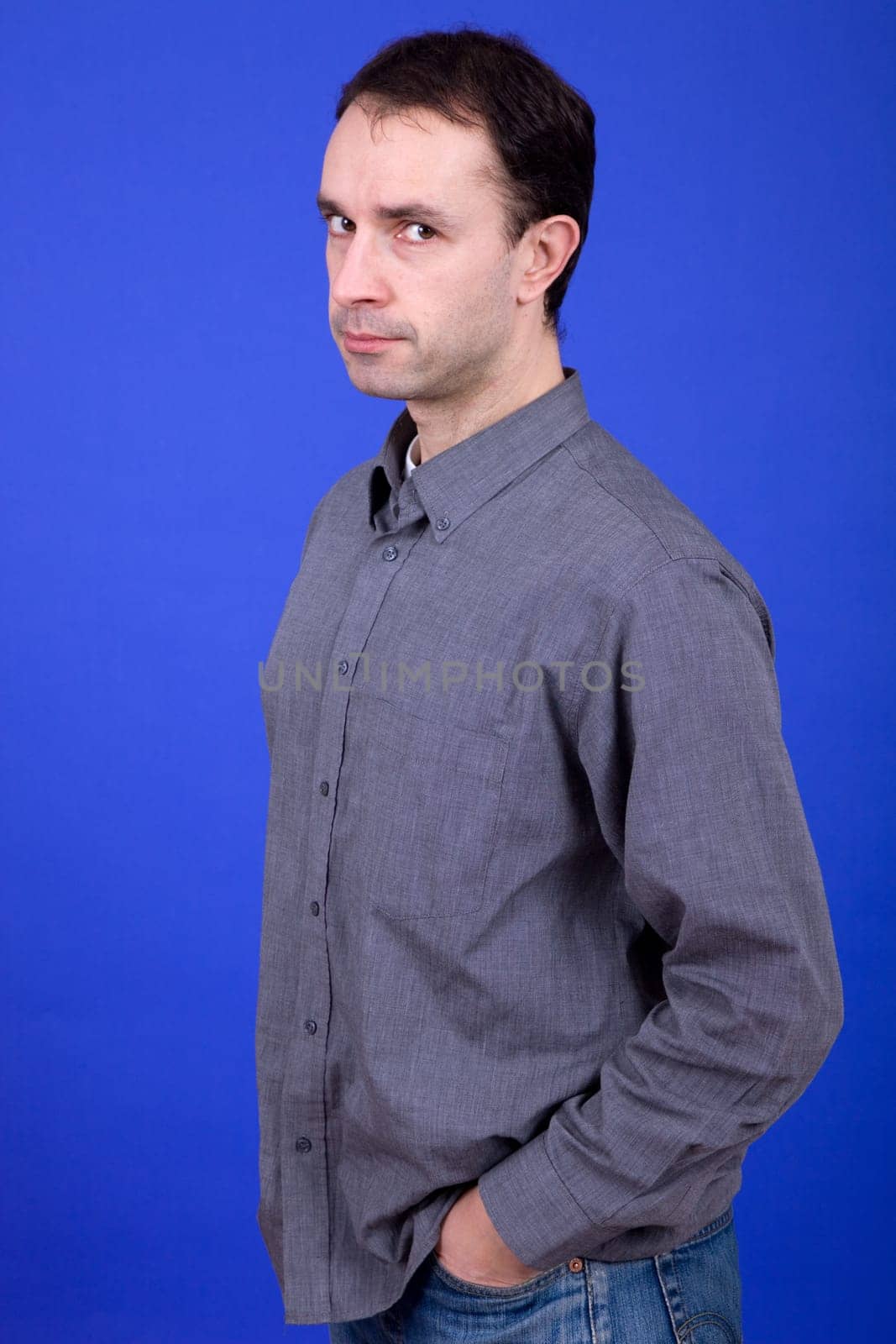 an young man portrait over a blue background