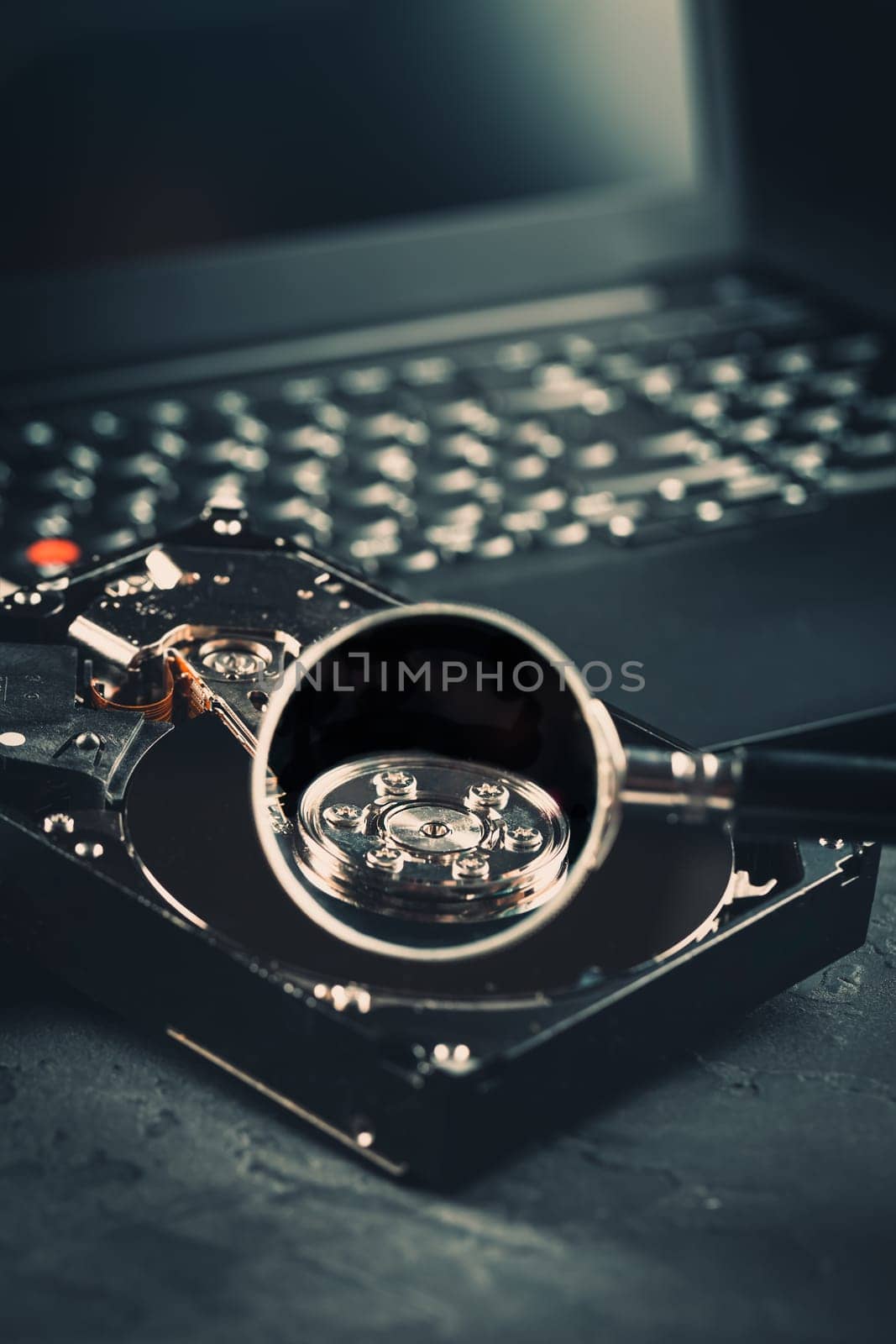 Open Hard drive on keyboard of laptop or notebook in dark tone