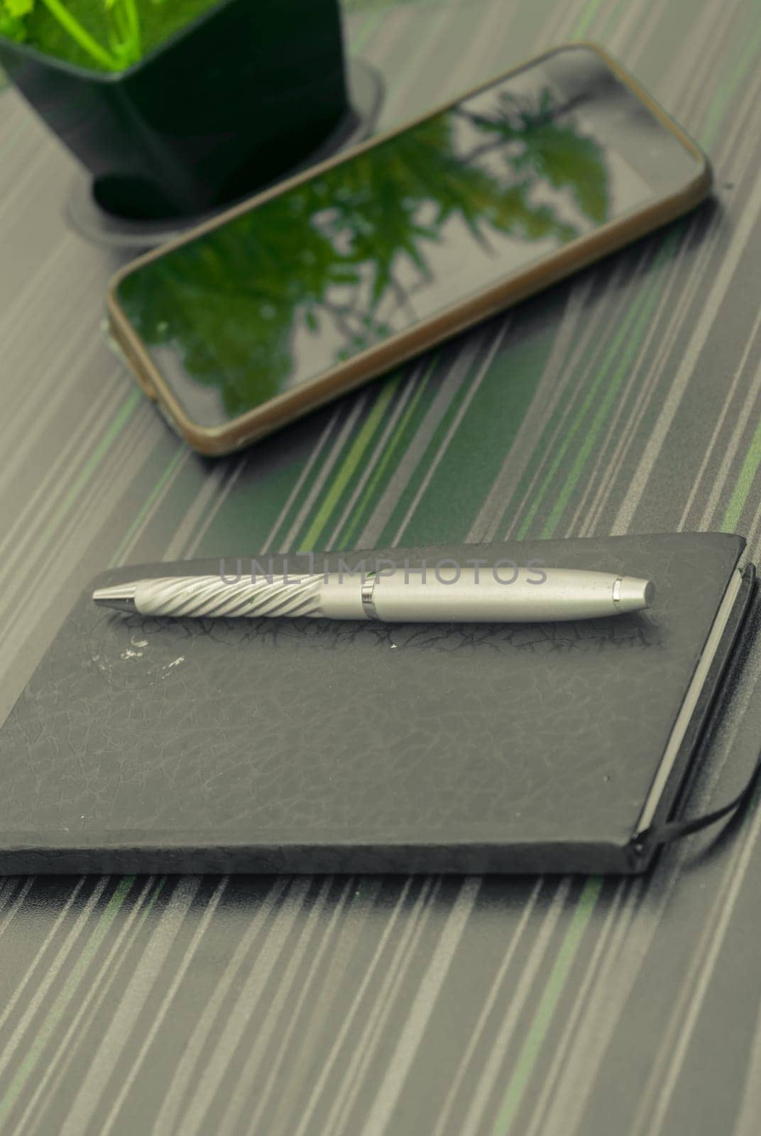 Pen and notebook on office table. Table top view. Corporate business background.