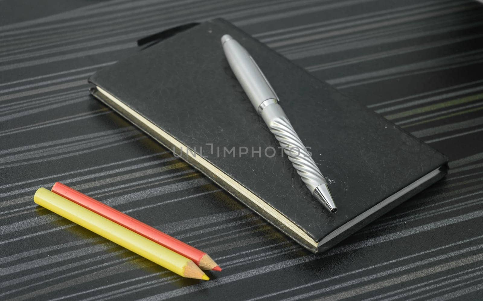 Pen and notebook on office table. Table top view. Corporate business background.