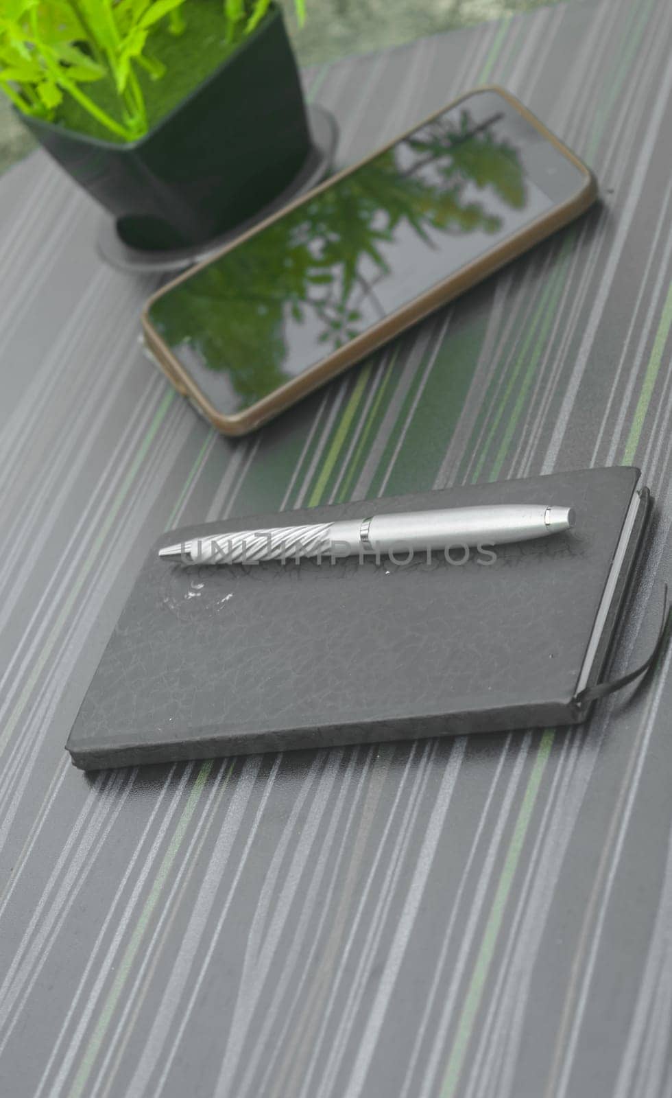 Pen and notebook on office table. Table top view. Corporate business background.